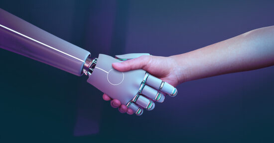 A robot and human shake hand